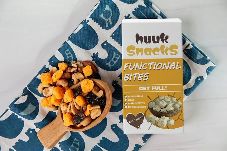 gluten free sugar free keto friendly high protein cheddar believe it moon cheese with trail mix and the package on a colorful napkin