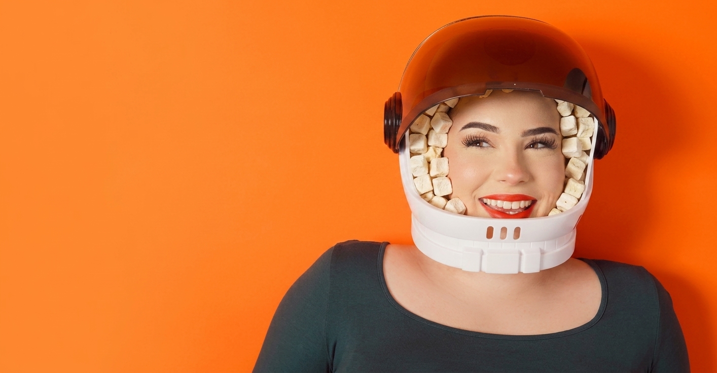 Smiling young woman with a space helmet filled with high protein gluten free sugar free moon cheese